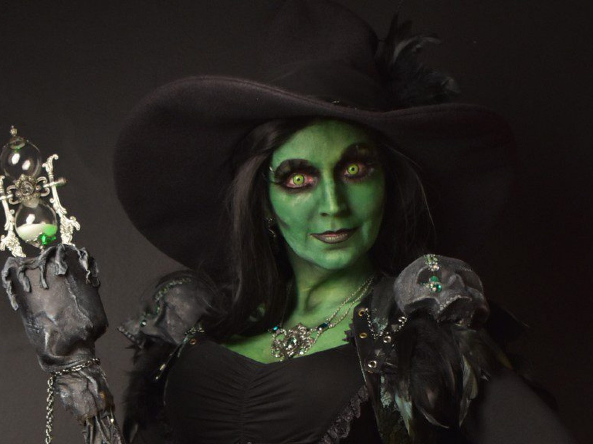 woman painted with green face paint as witch