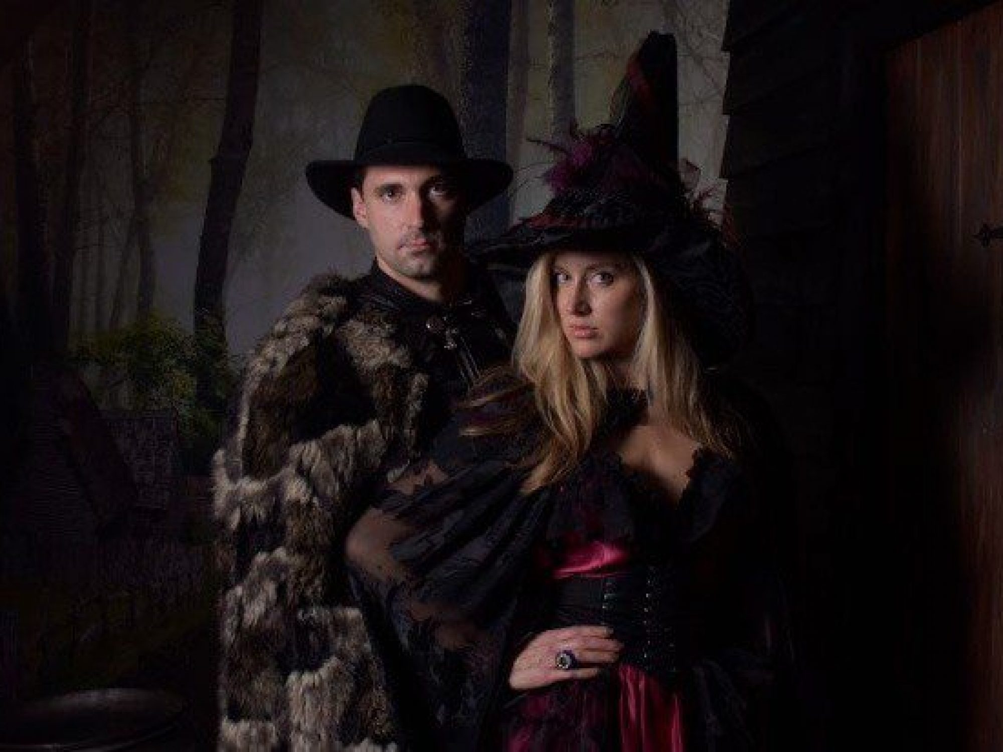 Man and woman in fur and witch costumes.